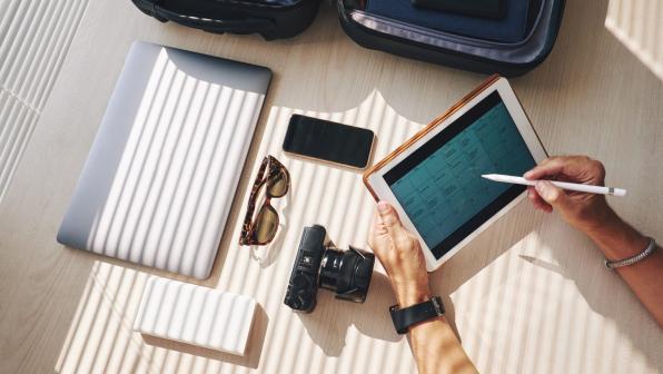 Close-up of businessman planning his work in touchpad