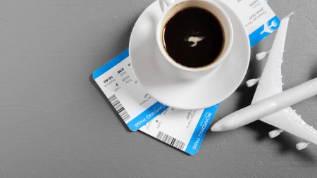 boarding pass and toy airplane on table top view